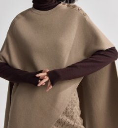 Cashmere knitwear layered over a shawl, crewneck pullover cape top